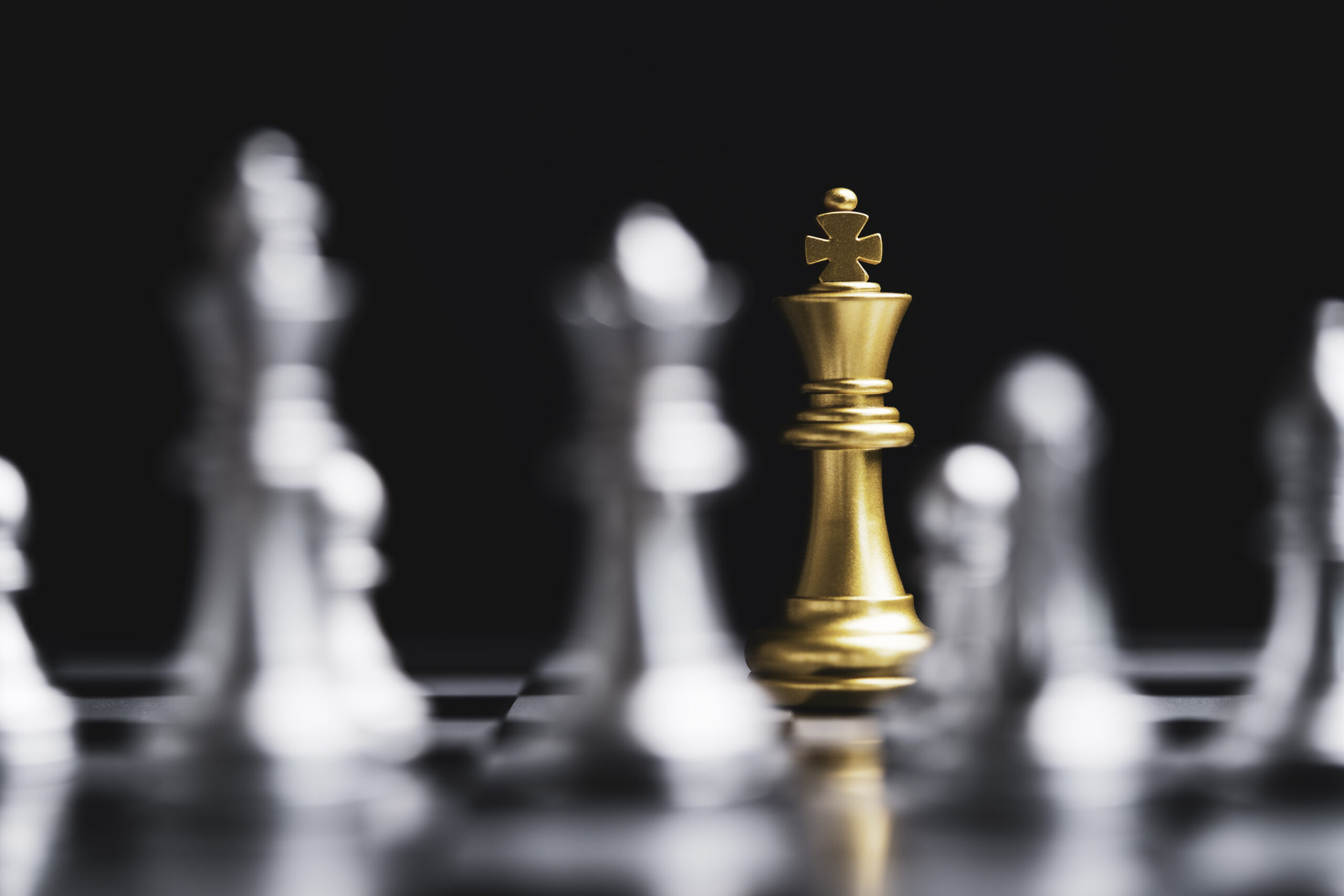 Golden king chess encounter with silver chess enemy on dark back